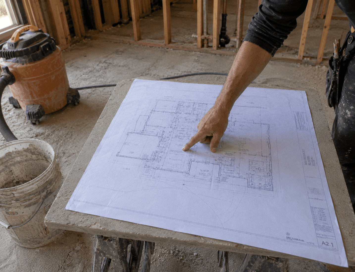 Reviewing architectural site plans on a job site